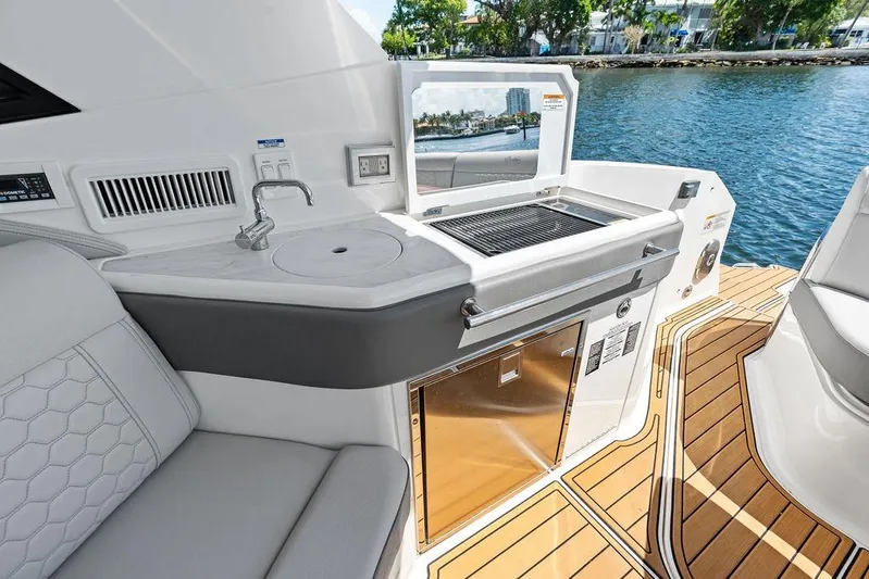 Maxsea Yacht Photos Pics 2022 Sea Ray Sundancer 320 Outboard boat interior with grill and sink by the water.
