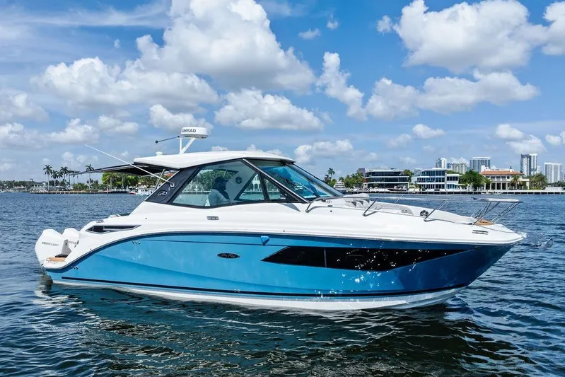 Maxsea Yacht Photos Pics 2022 Sea Ray Sundancer 320 Outboard cruising on a sunny day, blue and white design.