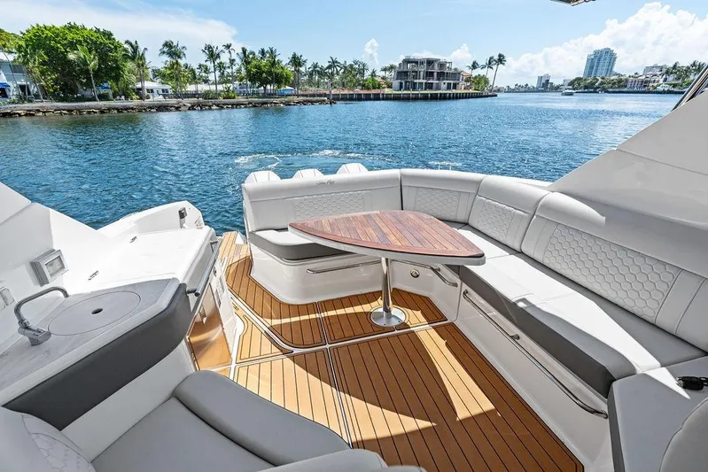 Maxsea Yacht Photos Pics Luxurious 2022 Sea Ray Sundancer 320 Outboard boat interior with elegant seating and wooden table.