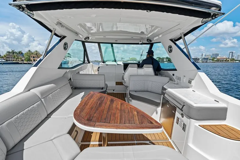 Maxsea Yacht Photos Pics Luxurious 2022 Sea Ray Sundancer 320 Outboard interior with elegant seating and wooden table.