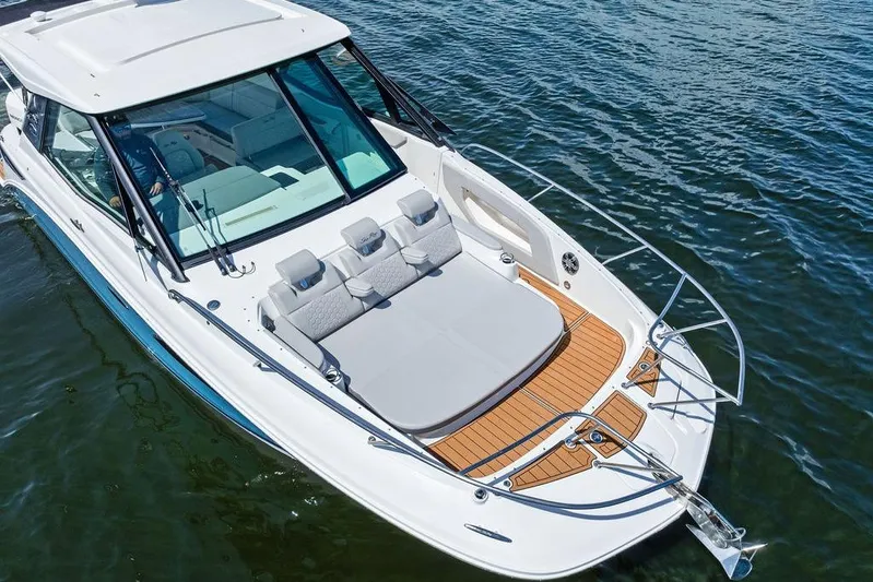 Maxsea Yacht Photos Pics 2022 Sea Ray Sundancer 320 Outboard cruising on water, featuring spacious deck and modern design.