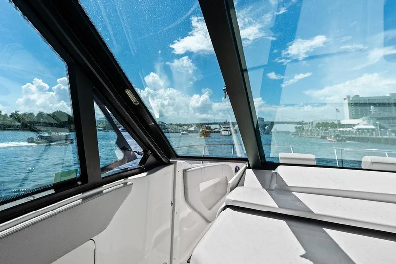 Maxsea Yacht Photos Pics 2022 Sea Ray Sundancer 320 Outboard interior with waterfront view through large windows.