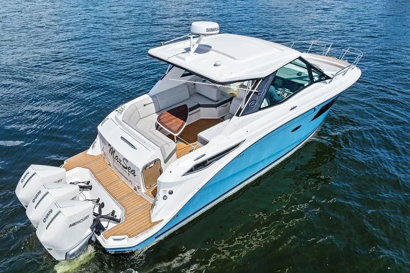 Maxsea Yacht Photos Pics 2022 Sea Ray Sundancer 320 Outboard cruising on water, featuring sleek design and powerful engines.