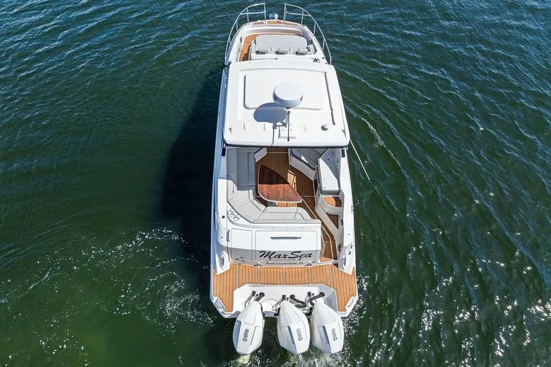 Maxsea Yacht Photos Pics 2022 Sea Ray Sundancer 320 Outboard cruising on open water, aerial view.