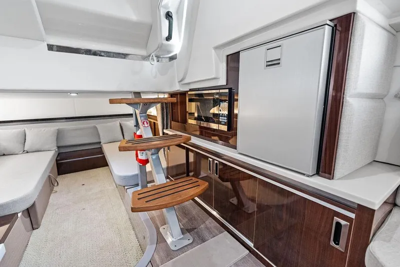 Maxsea Yacht Photos Pics 2022 Sea Ray Sundancer 320 Outboard interior with kitchenette and seating area.