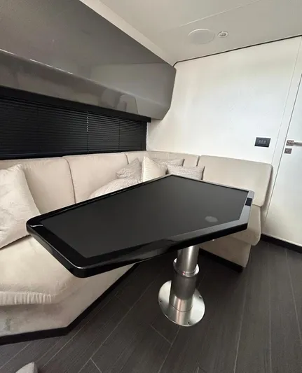 No Name Yacht Photos Pics 2024 Azimut Verve 48 interior with sleek black table and beige seating.