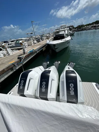 No Name Yacht Photos Pics 2024 Azimut Verve 48 with triple outboard engines docked at a marina.