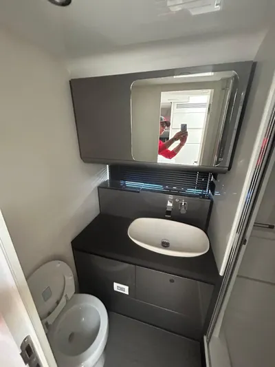 No Name Yacht Photos Pics 2024 Azimut Verve 48 yacht bathroom with modern sink, mirror, and toilet.