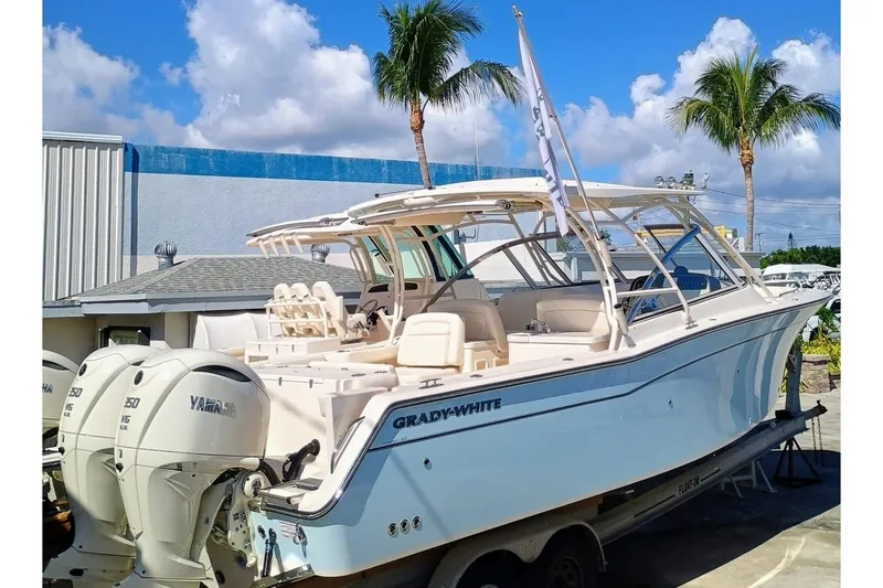 307-310 Yacht Photos Pics 2025 Grady-White Freedom 307 boat with Yamaha engines, docked under a sunny sky.