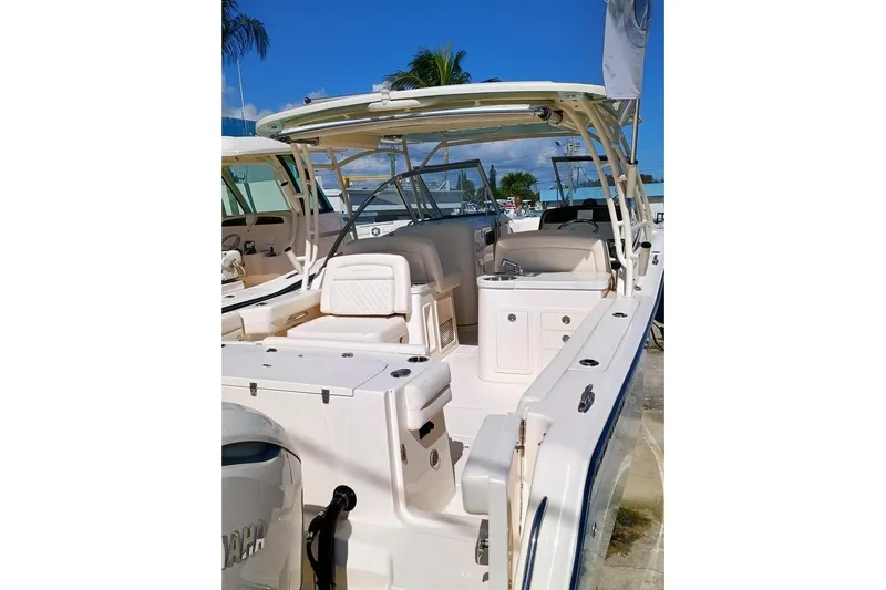 307-310 Yacht Photos Pics 2025 Grady-White Freedom 307 boat, spacious deck, luxurious seating, sunny marina backdrop.