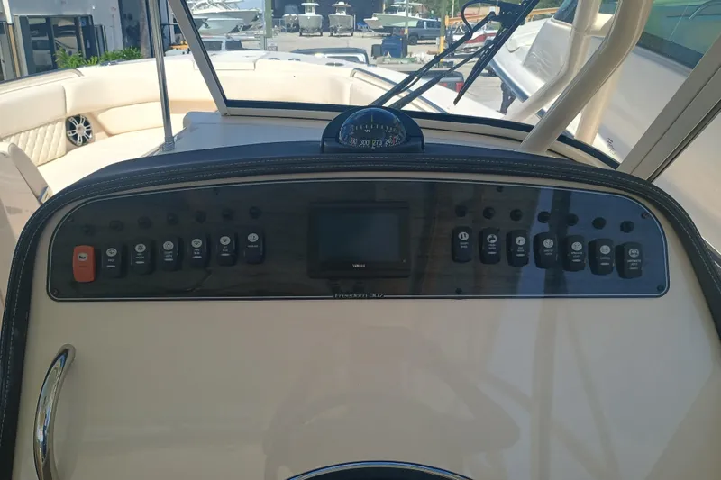 307-310 Yacht Photos Pics 2025 Grady-White Freedom 307 boat dashboard with controls and navigation display.
