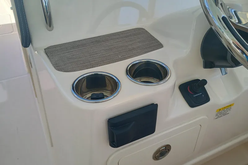 307-310 Yacht Photos Pics 2025 Grady-White Freedom 307 boat console with cup holders and controls.