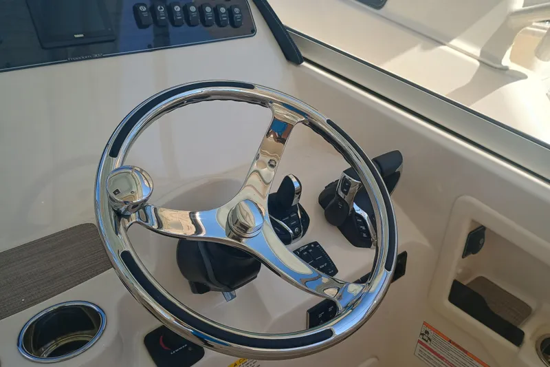 307-310 Yacht Photos Pics Steering wheel and controls of 2025 Grady-White Freedom 307 boat cockpit.