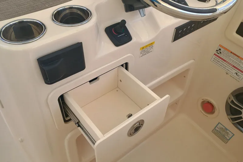 307-310 Yacht Photos Pics 2025 Grady-White Freedom 307 boat console with open storage drawer and cup holders.