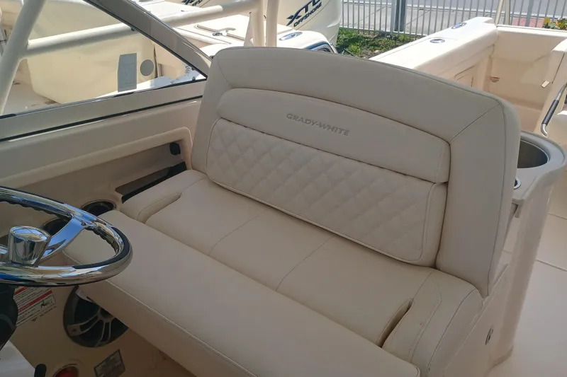 307-310 Yacht Photos Pics 2025 Grady-White Freedom 307 boat interior with luxurious seating and steering wheel.