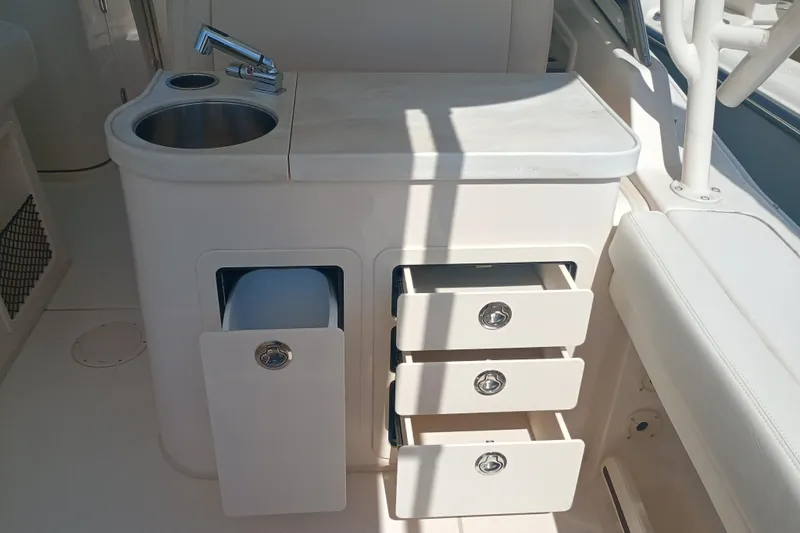 307-310 Yacht Photos Pics Interior of 2025 Grady-White Freedom 307 boat with sink and storage drawers.