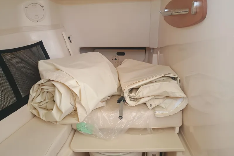 307-310 Yacht Photos Pics Interior of 2025 Grady-White Freedom 307 boat with folded canvas and storage area.