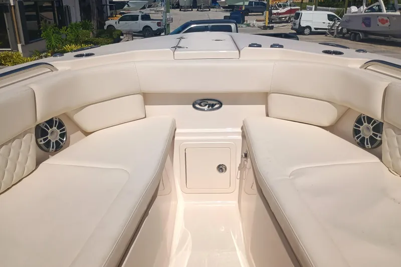 307-310 Yacht Photos Pics 2025 Grady-White Freedom 307 boat interior with cushioned seating and speakers.
