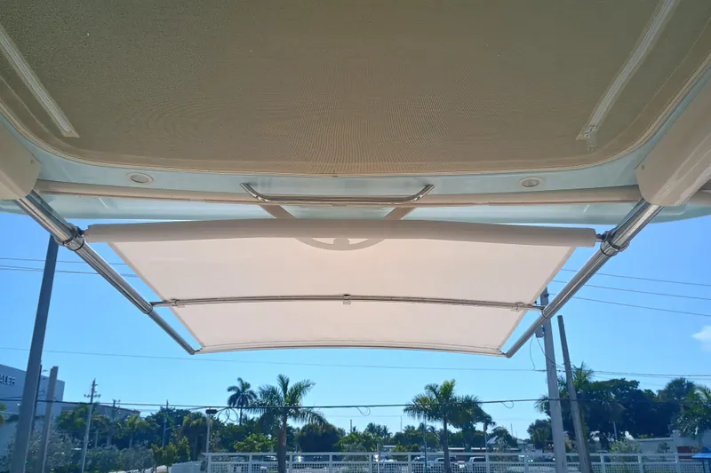 307-310 Yacht Photos Pics 2025 Grady-White Freedom 307 boat canopy with clear sky and palm trees.
