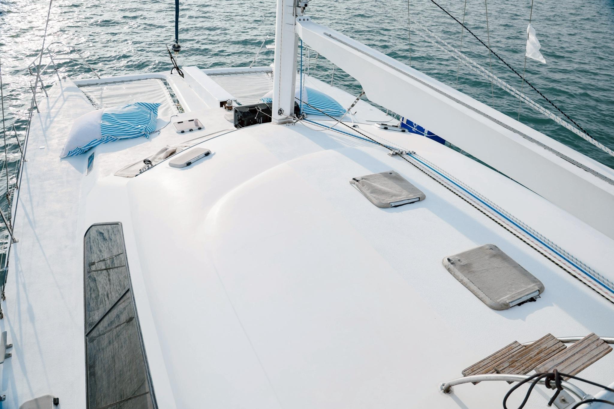 Deck of 2001 IMP 55 sailboat with cushions, hatches, and ocean view.