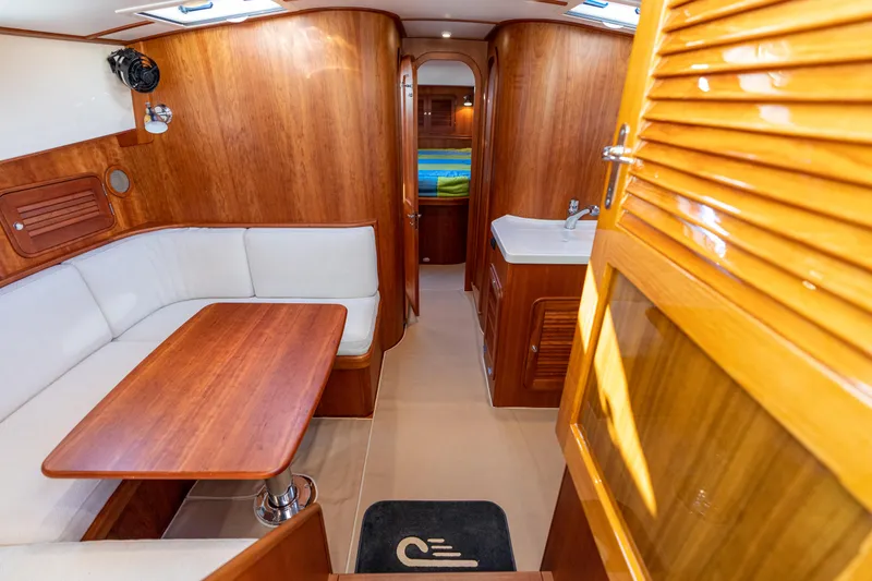 Upshort Yacht Photos Pics Luxurious interior of 2010 Hinckley Talaria 44 MKII Express yacht with wood finish and seating area.