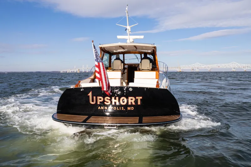 Upshort Yacht Photos Pics Hinckley Talaria 44 MKII Express yacht cruising on open water, rear view, 2010 model.