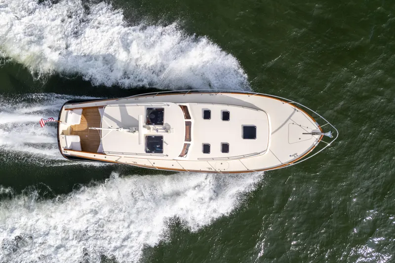 Upshort Yacht Photos Pics Hinckley Talaria 44 MKII Express 2010 cruising on water, aerial view.
