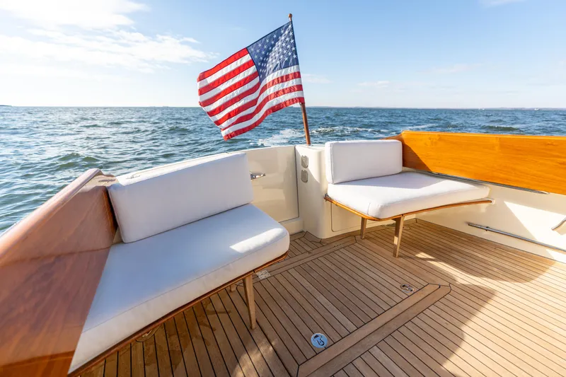 Upshort Yacht Photos Pics Hinckley Talaria 44 MKII Express 2010 yacht deck with American flag, ocean view.