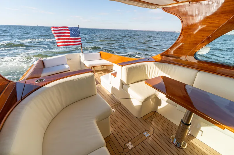 Upshort Yacht Photos Pics Luxurious 2010 Hinckley Talaria 44 MKII Express yacht with elegant seating and American flag.