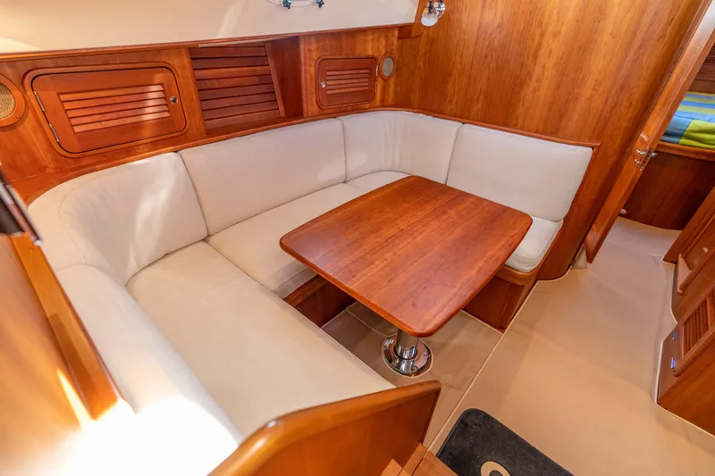 Upshort Yacht Photos Pics Luxurious interior of 2010 Hinckley Talaria 44 MKII Express with elegant wood finish and cozy seating.