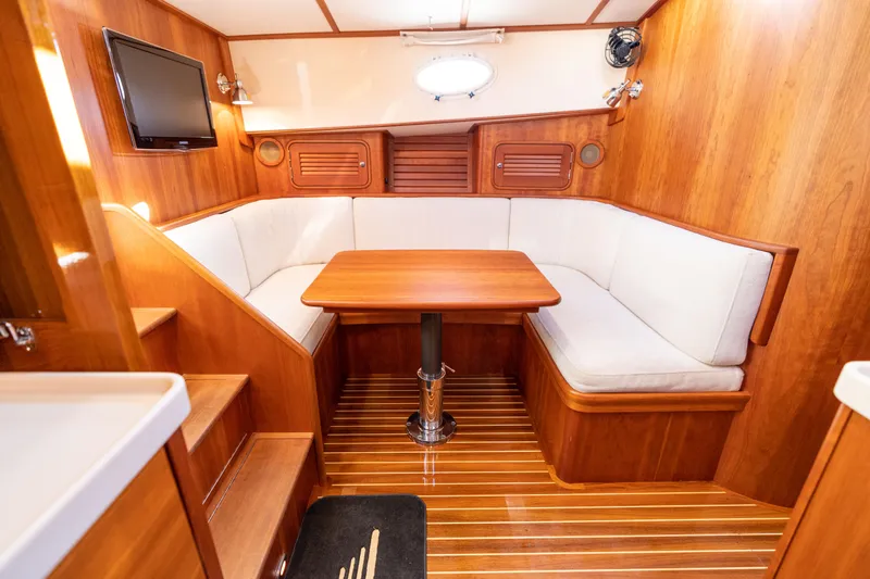 Upshort Yacht Photos Pics Luxurious interior of 2010 Hinckley Talaria 44 MKII Express yacht with wood finish and seating area.