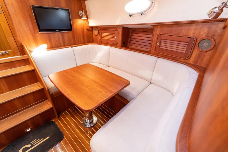 Upshort Yacht Photos Pics Luxurious 2010 Hinckley Talaria 44 MKII Express yacht interior with elegant wood and white seating.