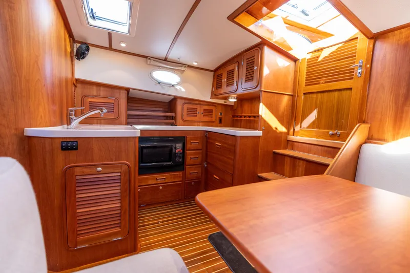 Upshort Yacht Photos Pics Interior of 2010 Hinckley Talaria 44 MKII Express yacht with wooden cabinetry and modern amenities.