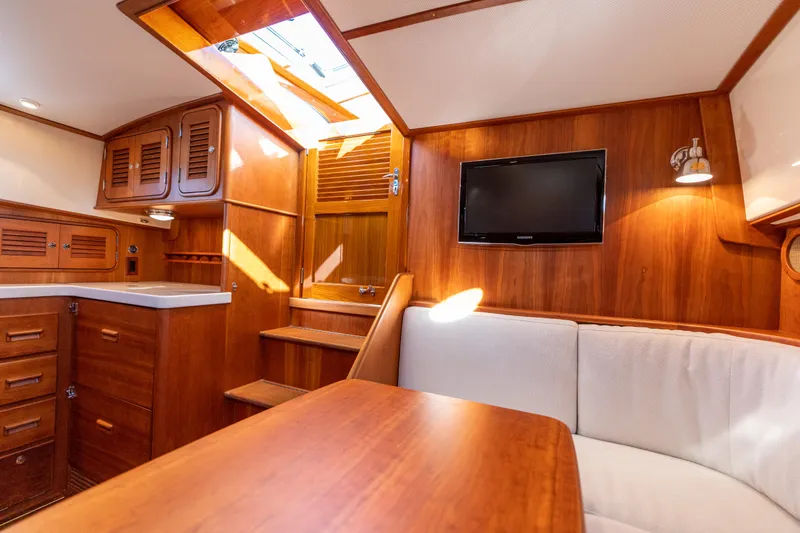Upshort Yacht Photos Pics Interior of 2010 Hinckley Talaria 44 MKII Express yacht with wood finish and seating area.
