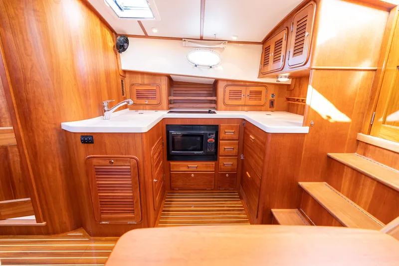Upshort Yacht Photos Pics Luxurious wooden interior of 2010 Hinckley Talaria 44 MKII Express yacht kitchen.