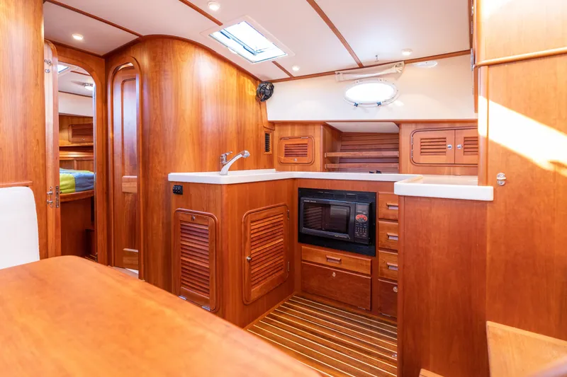 Upshort Yacht Photos Pics Luxurious 2010 Hinckley Talaria 44 MKII Express yacht interior with wood finish and modern amenities.
