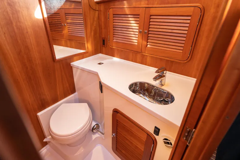 Upshort Yacht Photos Pics Luxurious 2010 Hinckley Talaria 44 MKII Express yacht bathroom with wooden cabinetry and modern fixtures.