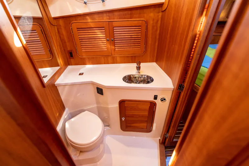 Upshort Yacht Photos Pics Luxurious 2010 Hinckley Talaria 44 MKII Express yacht bathroom with wooden cabinetry and modern fixtures.