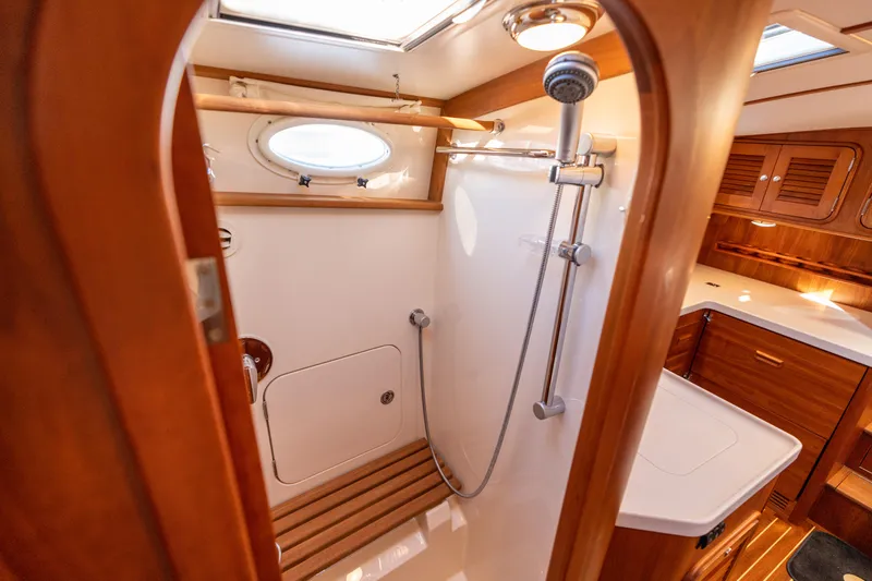 Upshort Yacht Photos Pics Luxurious 2010 Hinckley Talaria 44 MKII Express yacht bathroom with wooden accents and shower.