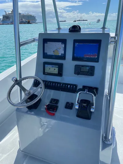 Swell Chaser Yacht Photos Pics 2005 Contender 31 boat helm with navigation systems and controls.
