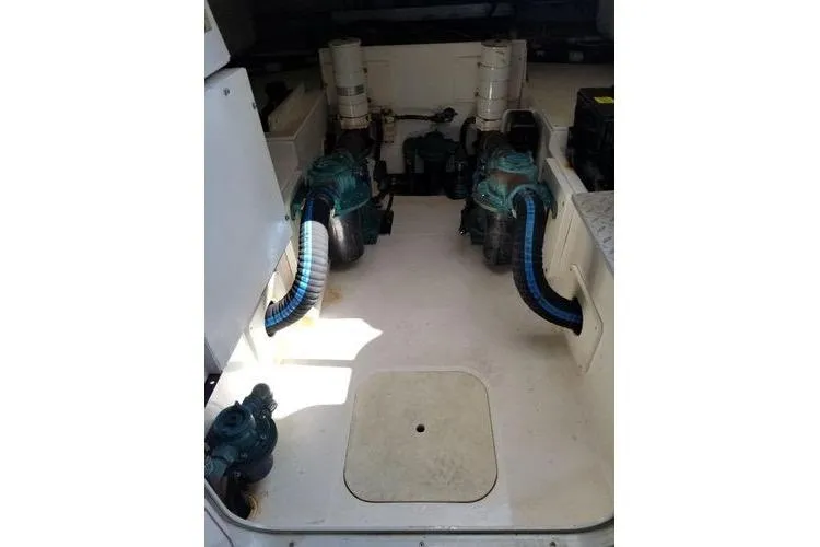  Yacht Photos Pics Engine room of 2005 Luhrs 41 Convertible boat with visible machinery and hoses.
