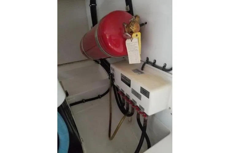  Yacht Photos Pics 2005 Luhrs 41 Convertible engine room with fire extinguisher and control panel.