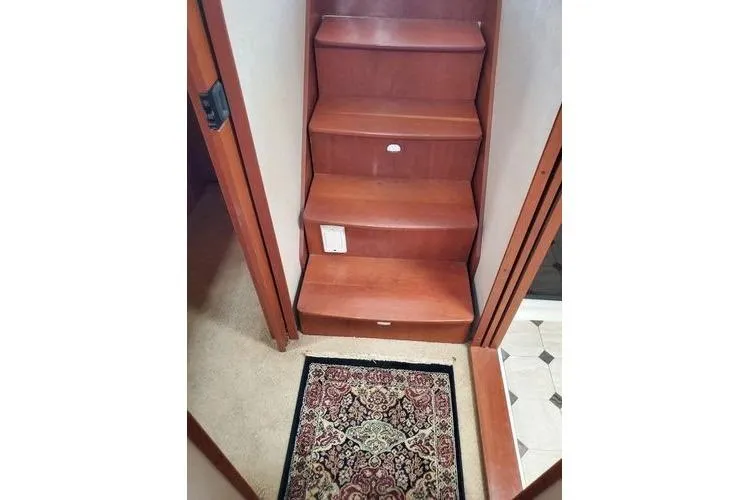  Yacht Photos Pics Staircase inside 2005 Luhrs 41 Convertible boat with decorative rug.