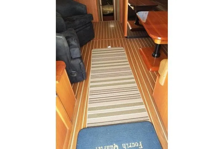  Yacht Photos Pics Interior of 2005 Luhrs 41 Convertible yacht with striped rug and wooden flooring.