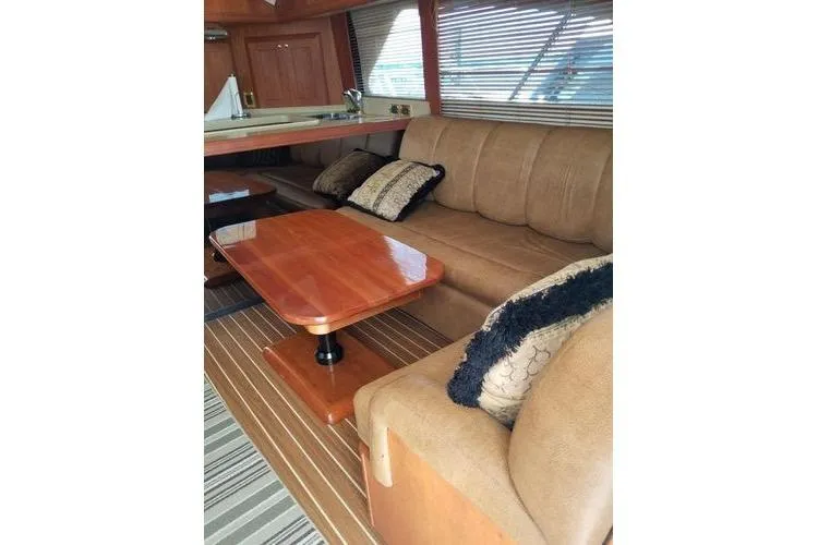  Yacht Photos Pics Luxurious interior of 2005 Luhrs 41 Convertible yacht with plush seating and wooden table.