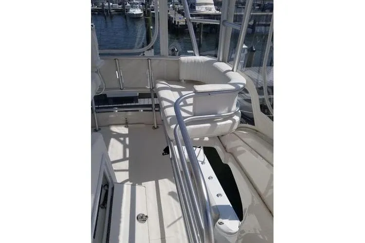  Yacht Photos Pics 2005 Luhrs 41 Convertible yacht interior with white seating and railing, docked at marina.