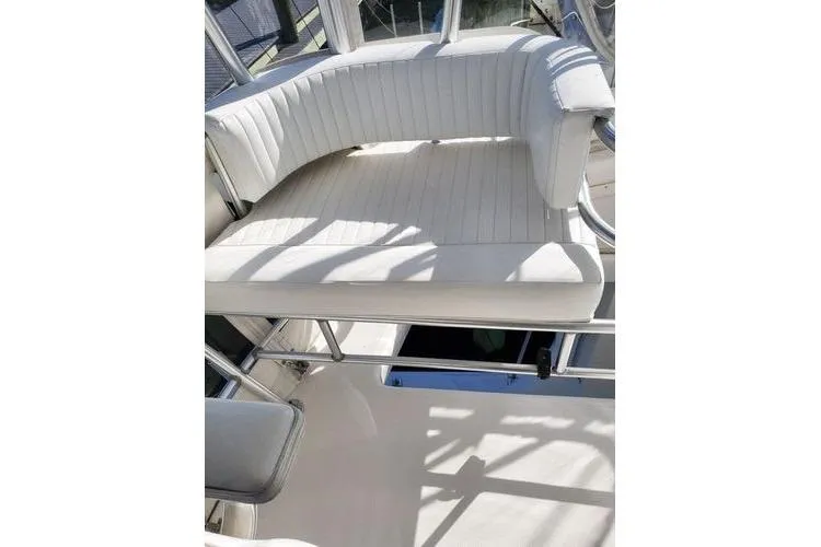  Yacht Photos Pics 2005 Luhrs 41 Convertible boat with white cushioned seating area.
