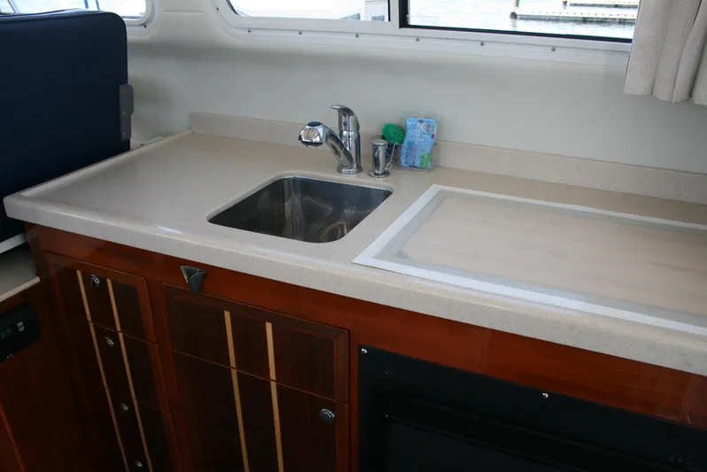 Gypsy Spirit Yacht Photos Pics 2011 Ocean Sport Roamer 30' interior kitchen with sink and countertop.