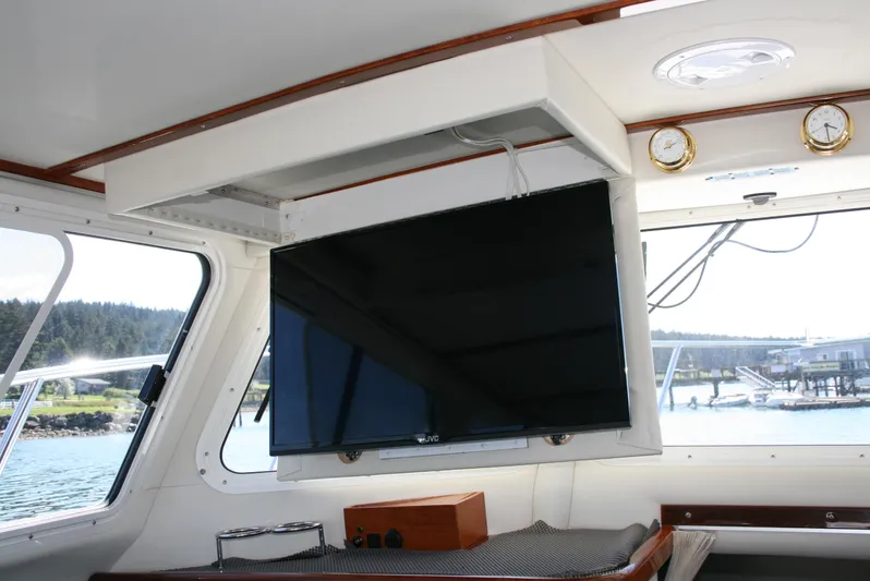 Gypsy Spirit Yacht Photos Pics Interior of 2011 Ocean Sport Roamer 30' with mounted TV and scenic window view.