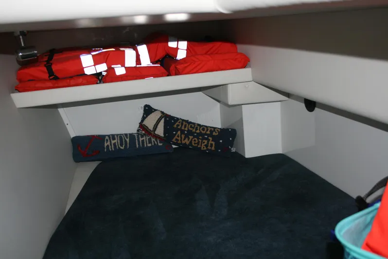 Gypsy Spirit Yacht Photos Pics Cozy cabin interior of 2011 Ocean Sport Roamer 30' with life jackets and nautical pillows.